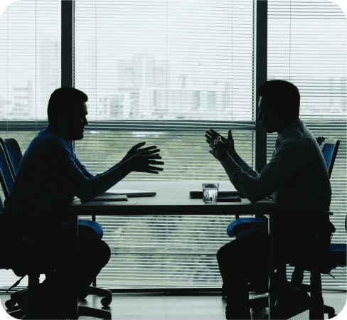 Two guys talking in a metting room